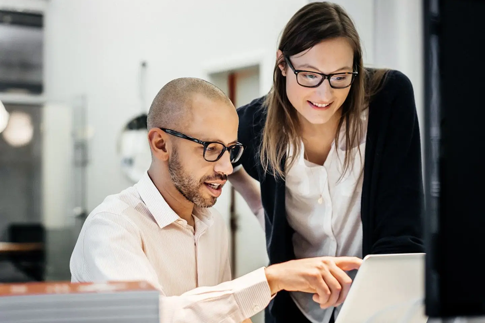 Two colleagues collaborating in an office.